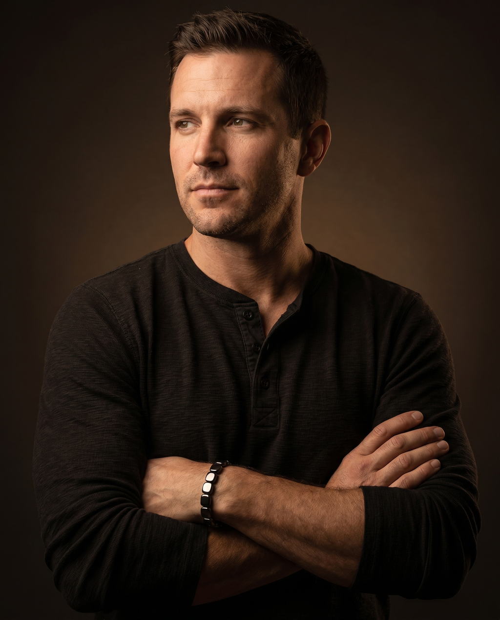 Man wearing the CAIRN bracelet, arms crossed